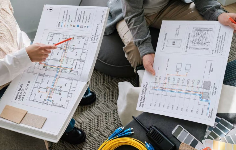Project team reviewing telecommunications engineering plans